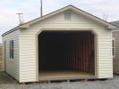 Pine Creek 14x24 Peak Garage with Classic Sand walls, Clay trim and Green Raised Panel shutters, and Shakewood shingles